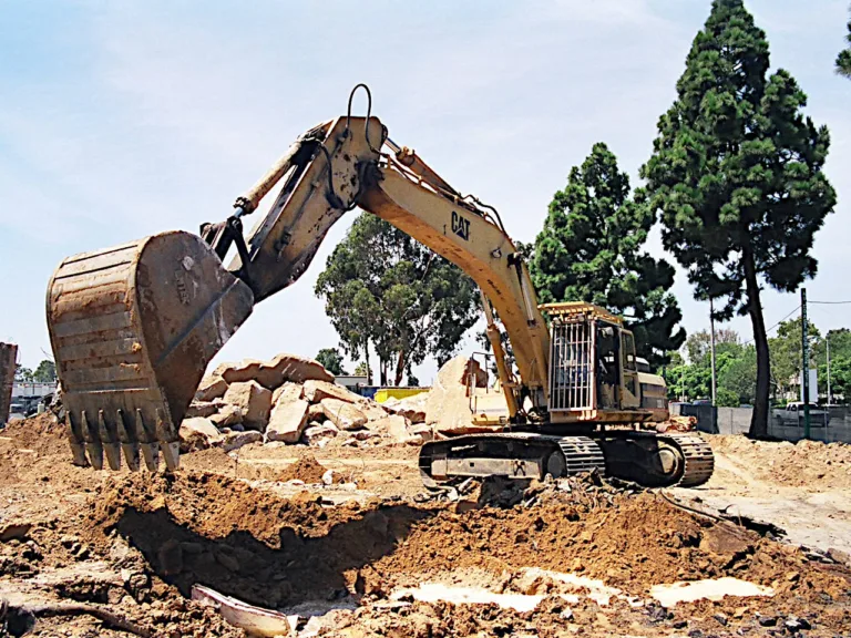 Excavator performing site demolition on a commercial lot in Los Angeles