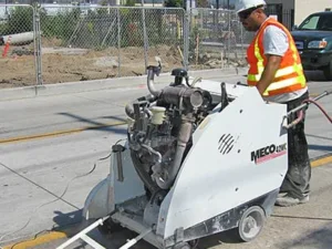 walk behind concrete cutting saw being used during carmax demolition project - side view