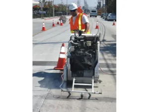 walk behind concrete cutting saw being used during carmax demolition project - front view