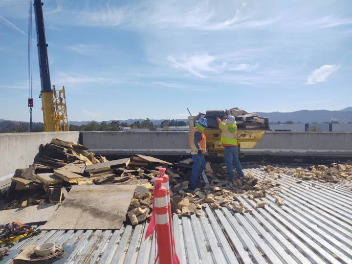 removing concrete debris from roof top at takeda pharmaceuticals construction site
