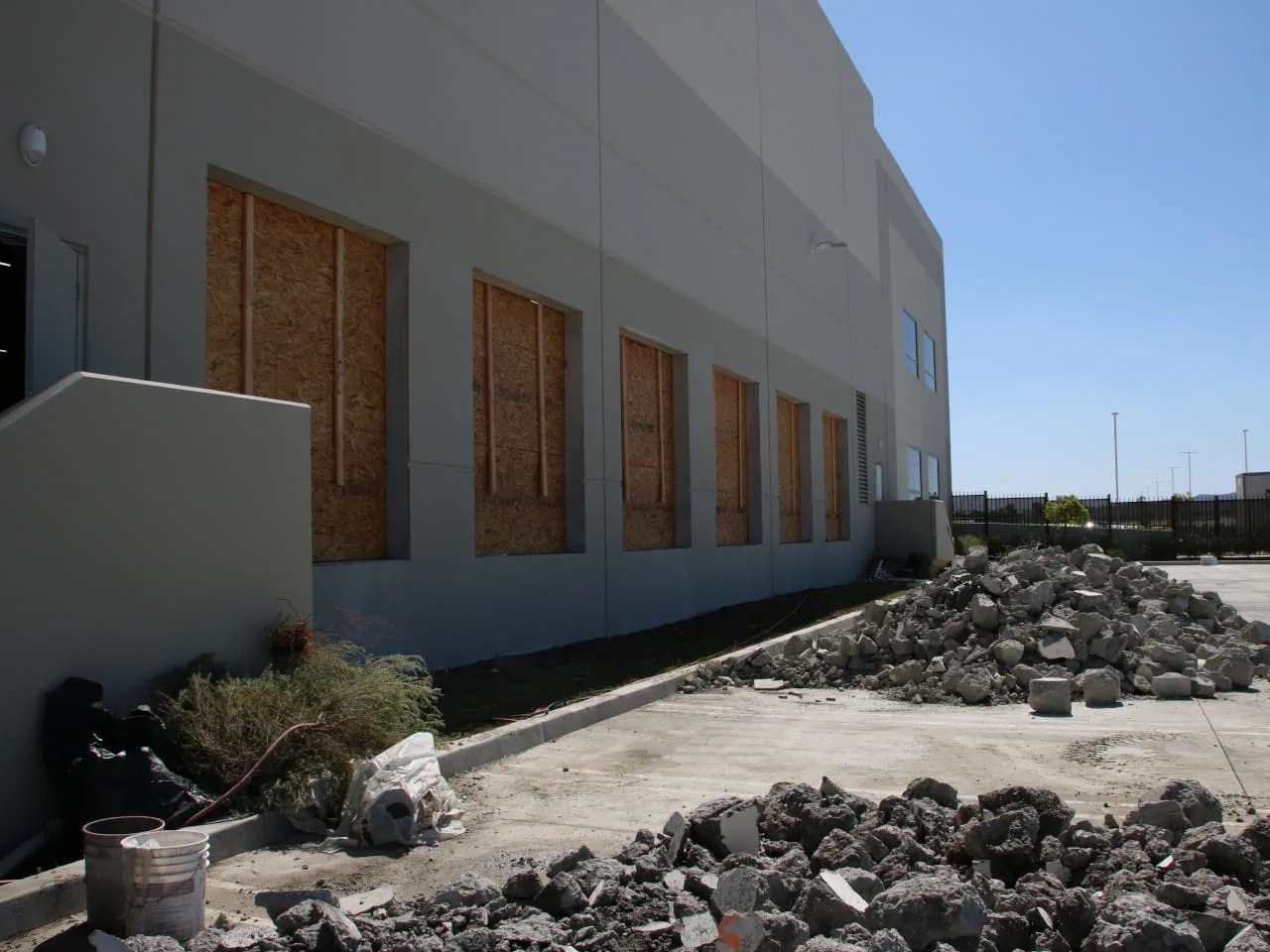 concrete cutting wall openings boarded up with plywood at ups facility in riverside, ca